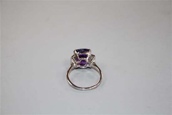 A white metal, amethyst and six stone diamond set dress ring, size R/S, gross weight 6.2 grams.